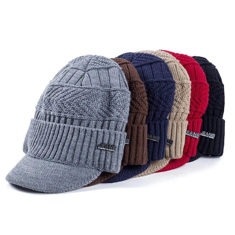 A display of various colored knit beanies with brims, including gray, blue, brown, beige, red, and black.