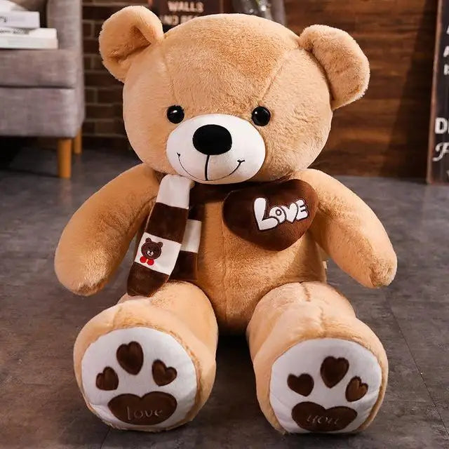 A brown plush teddy bear wearing a brown and white striped knit scarf sitting on a dark surface.