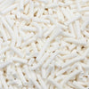 A close-up view of white soft polymer clay candy sprinkles for cake decorating.
