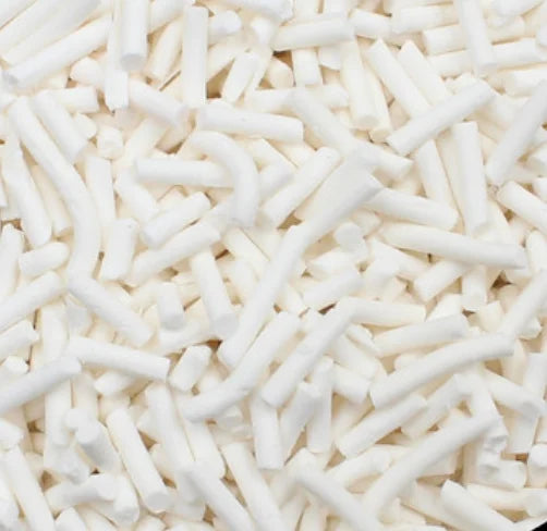 A close-up view of white soft polymer clay candy sprinkles for cake decorating.