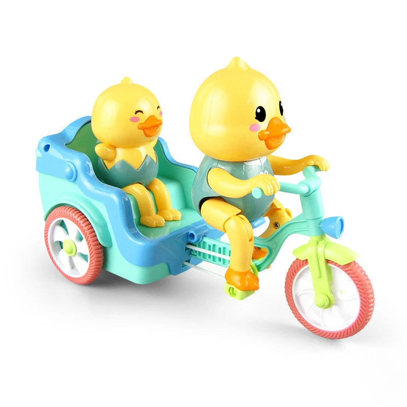 A yellow duck toy is seated in a blue electric tricycle with green accents.
