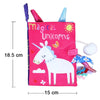 A pink cloth book featuring a unicorn design with colorful glitter accents and animal tails for baby sensory development.