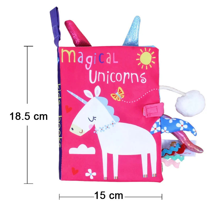 A pink cloth book featuring a unicorn design with colorful glitter accents and animal tails for baby sensory development.
