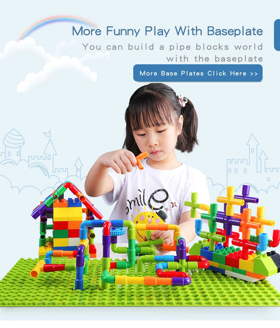 A young girl is building a colorful pipe blocks world using baseplates and various colored plastic pieces on a green mat.
