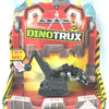 A Dinotrux toy truck and dinosaur figures packaged in a cardboard box.