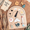 A wooden daily calendar for kids showing weather symbols, temperature, and wind direction.