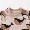 A beige long sleeve pullover sweatshirt featuring a repeating black whale print on the front.