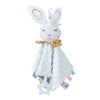 A white plush baby comforter security toy featuring bunny ears and a teether.