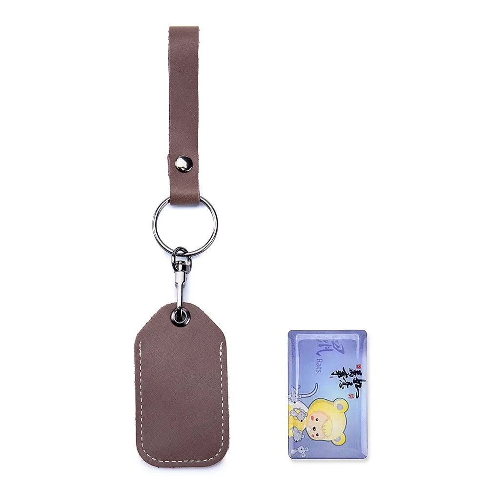 A brown leather key wallet with a metal ring and a card holder attached to a strap.