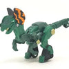 A green die-cast dinosaur truck toy with a removable dinosaur figure.