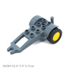 Gray plastic city traffic building block set featuring a structure with multiple openings and a yellow wheel.