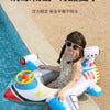 A child is sitting in a white and blue inflatable aircraft swim ring on a tiled poolside.