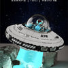 A model spaceship built from blocks, resembling a UFO, is displayed floating above a clear blue liquid.