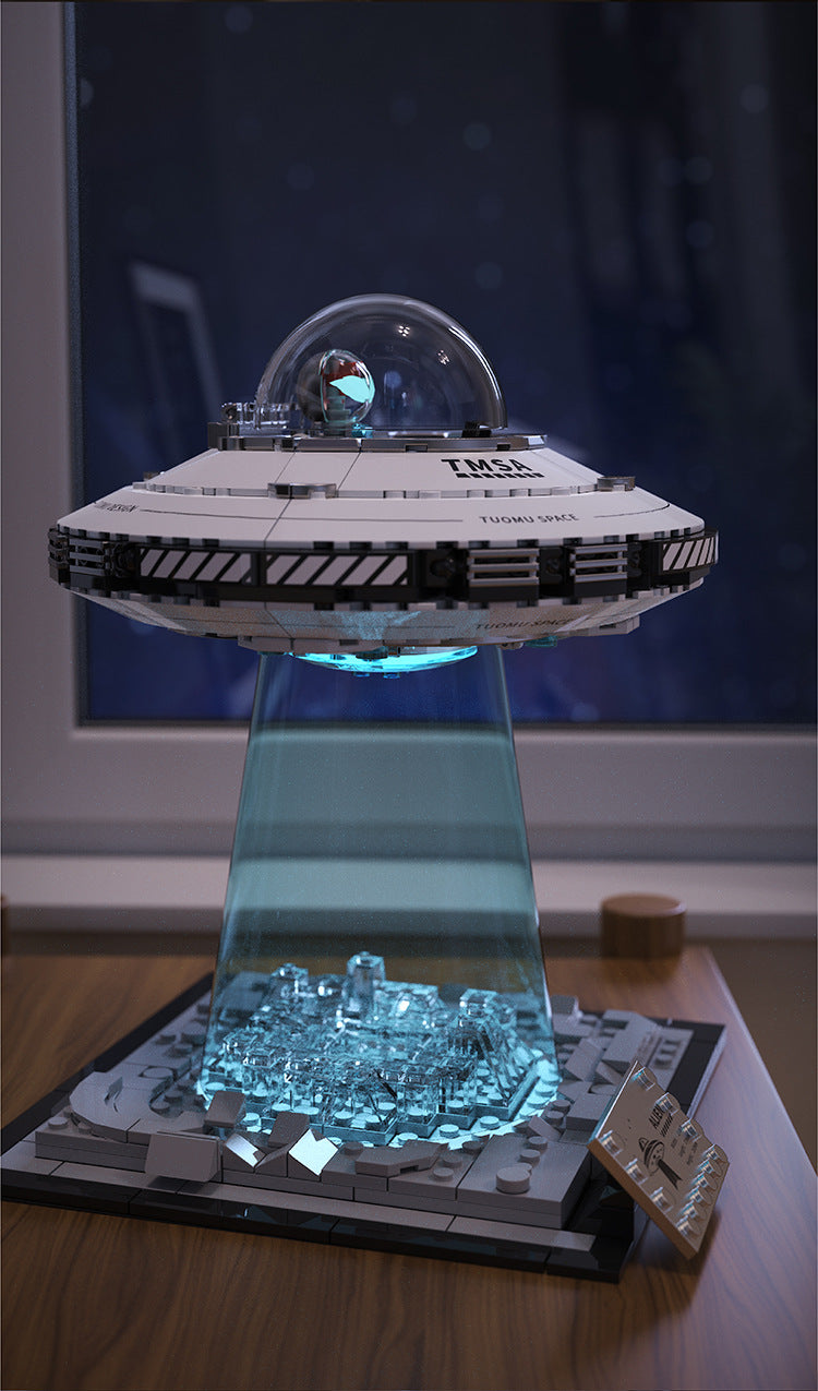 A model of a spaceship built from LEGO bricks, featuring a clear dome and illuminated details.