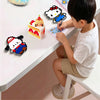 A young boy is crafting a Perler bead figure, demonstrating the use of colorful plastic beads on a white table.