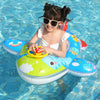 A smiling young girl wearing sunglasses is floating in a colorful inflatable aircraft swim ring in blue water.