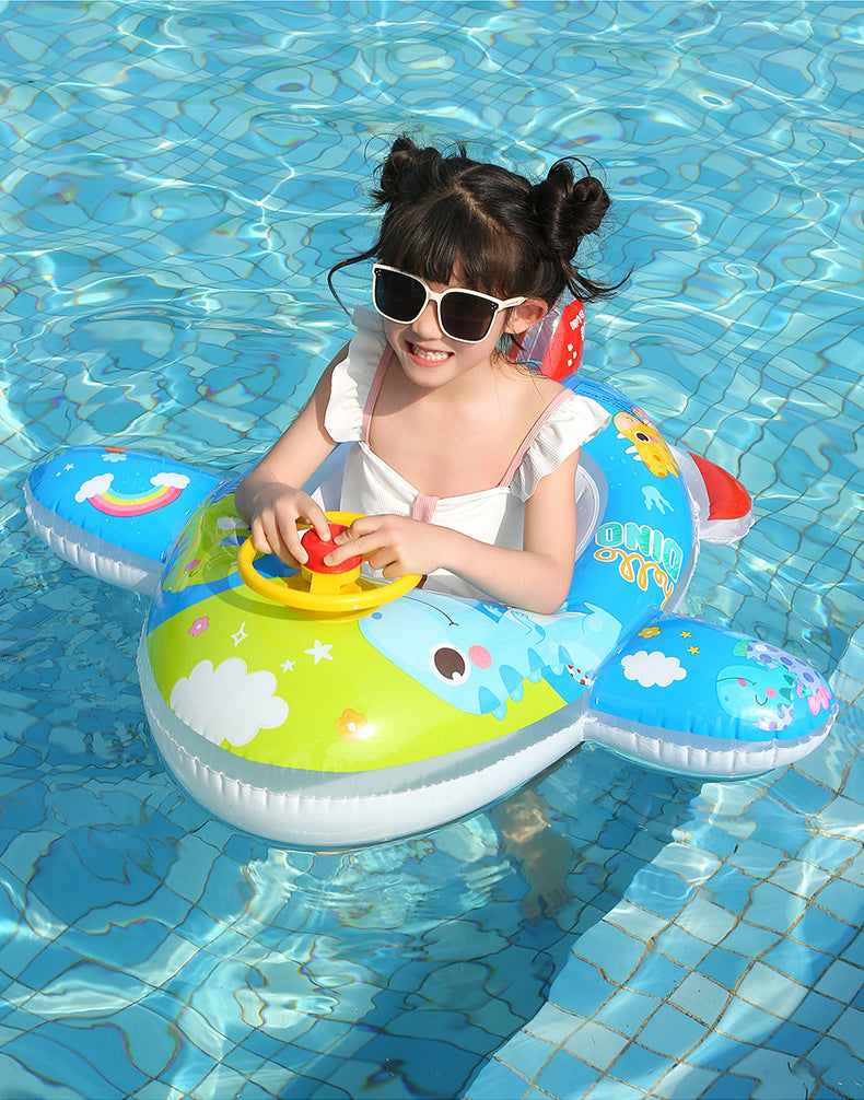 A smiling young girl wearing sunglasses is floating in a colorful inflatable aircraft swim ring in blue water.