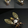 A detailed steampunk mechanical bee model kit featuring brass and silver metal parts with intricate wings.