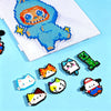 A Perler bead craft kit showing a blue and orange monster design on a white grid, with several finished animal figures scatte