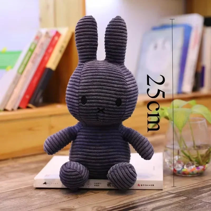 A gray Miffy plush toy rabbit standing on a book, with a vertical measurement line indicating its height of 25 cm.