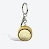 Silver keychain with a light yellow, ribbed silicone fidget toy attached.