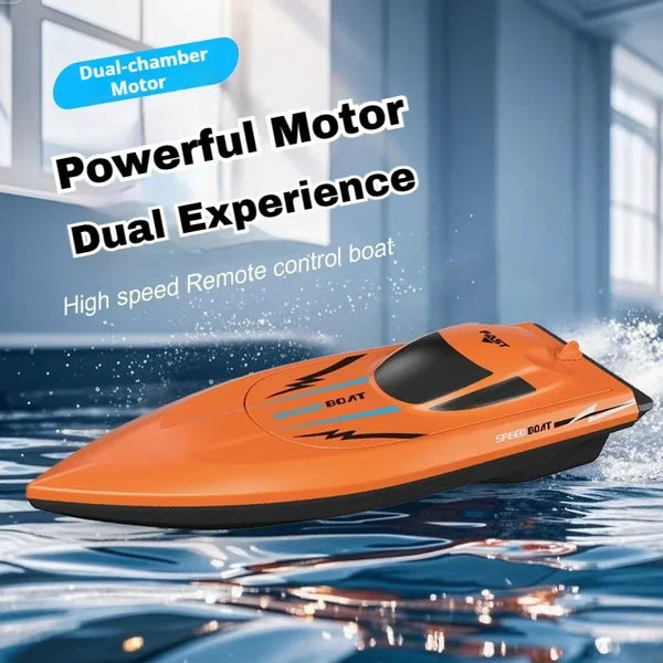 Orange remote controlled speed boat floating on water with a dual-chamber motor visible.