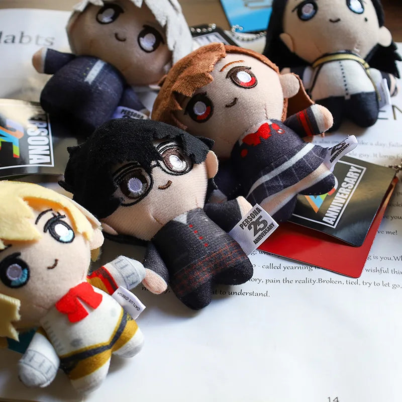 A collection of soft plushie character charms featuring anime style figures with dark hair and expressive eyes.