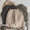 A set of beige and gray loose wide-leg harem pants for boys, including a pair of pants and a matching top.