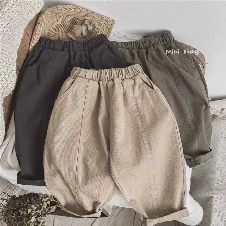 A set of beige and gray loose wide-leg harem pants for boys, including a pair of pants and a matching top.
