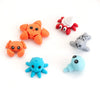 A set of five orange, red, and gray poseable 3D printed animal figurines on a white background.