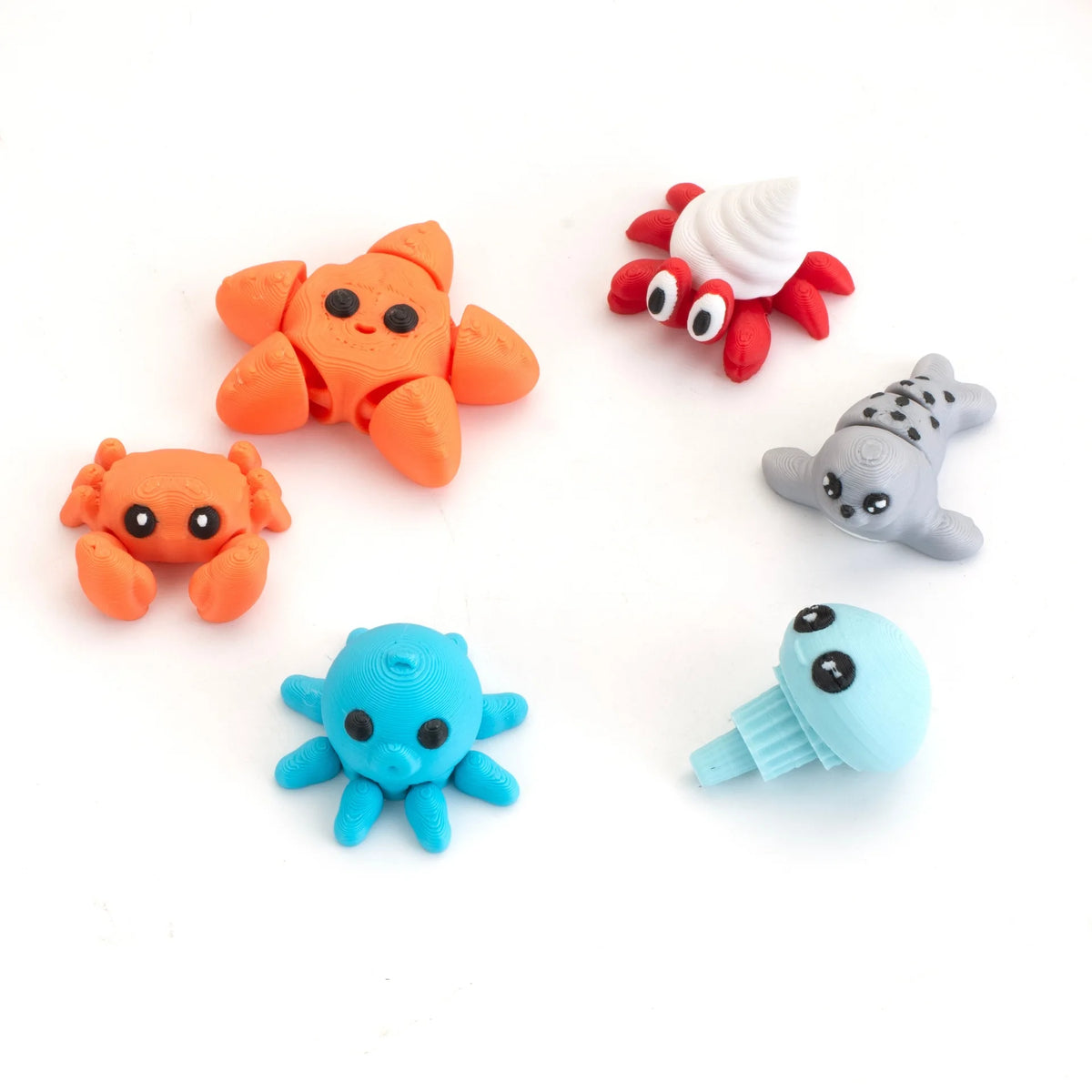 A set of five orange, red, and gray poseable 3D printed animal figurines on a white background.