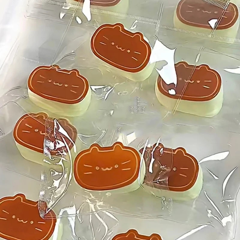 Several orange cat shaped squishy stress relief toys are packaged in clear plastic.