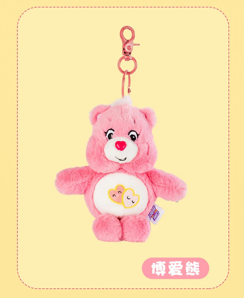 A pink Care Bears plush toy with a heart design attached to a silver keychain ring.