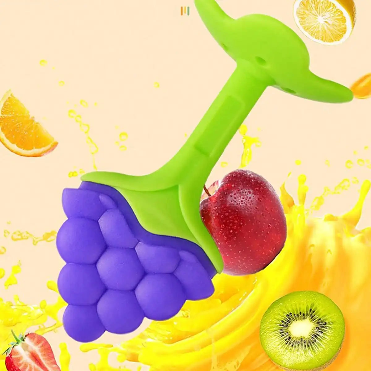 A bright green silicone fruit-shaped baby teether is shown surrounded by various fresh fruits like an apple, strawberry, and 