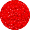 A close-up view of small, round red pony beads for jewelry making.
