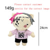 A plush doll with a light yellow body and pink accents, featuring text on the shirt.