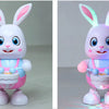 A white and pink musical robot rabbit toy with large ears, standing on its feet.