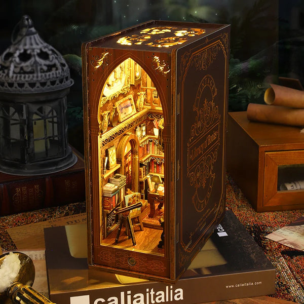 A wooden book nook puzzle kit featuring an intricate miniature scene with detailed architecture and figures.