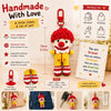 A handmade red crochet donkey doll with motivational card and accessories
