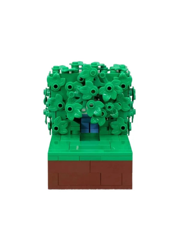 Maquette LEGO d'Homer dans les buissons, avec feuillage vert et socle marron
