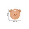 A light wooden bear-shaped musical instrument for toddlers, measuring 6cm high and 6.8cm wide.