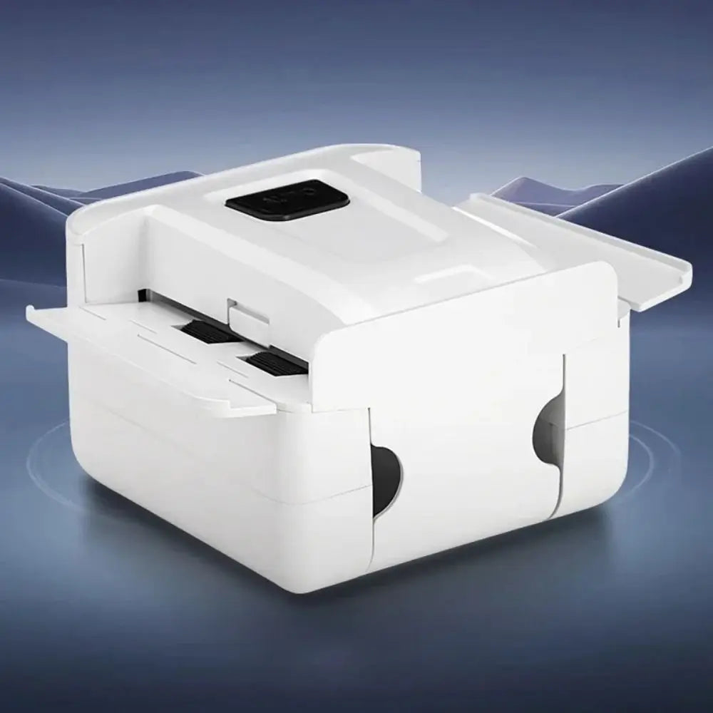 A white portable automatic card shuffler device with a flat top and battery compartment is shown on a dark surface.