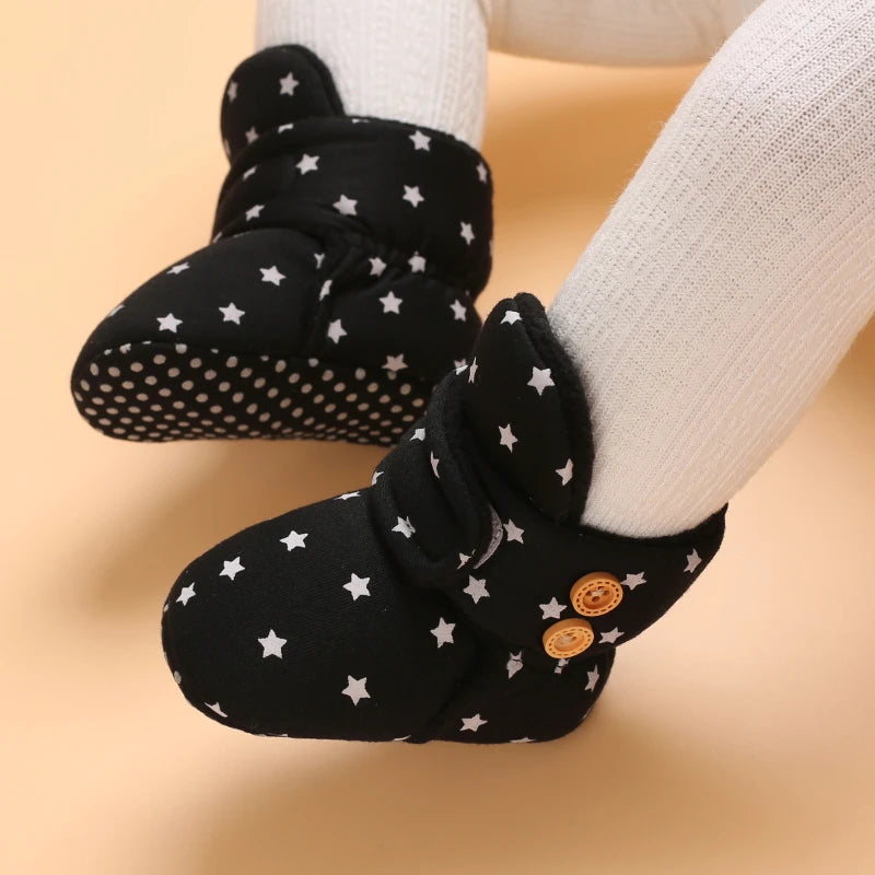 Black plush baby snow boots for girls and boys with a dotted sole and star pattern