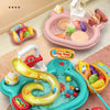 A pink plastic kitchen sink toy with running water and a yellow plastic snake for fishing game