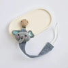 A gray elephant pacifier holder with a wooden clip is displayed on a light beige silicone tray.