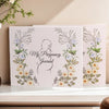 A set of three pregnancy journey journals featuring floral illustrations and a silhouette of a pregnant woman.