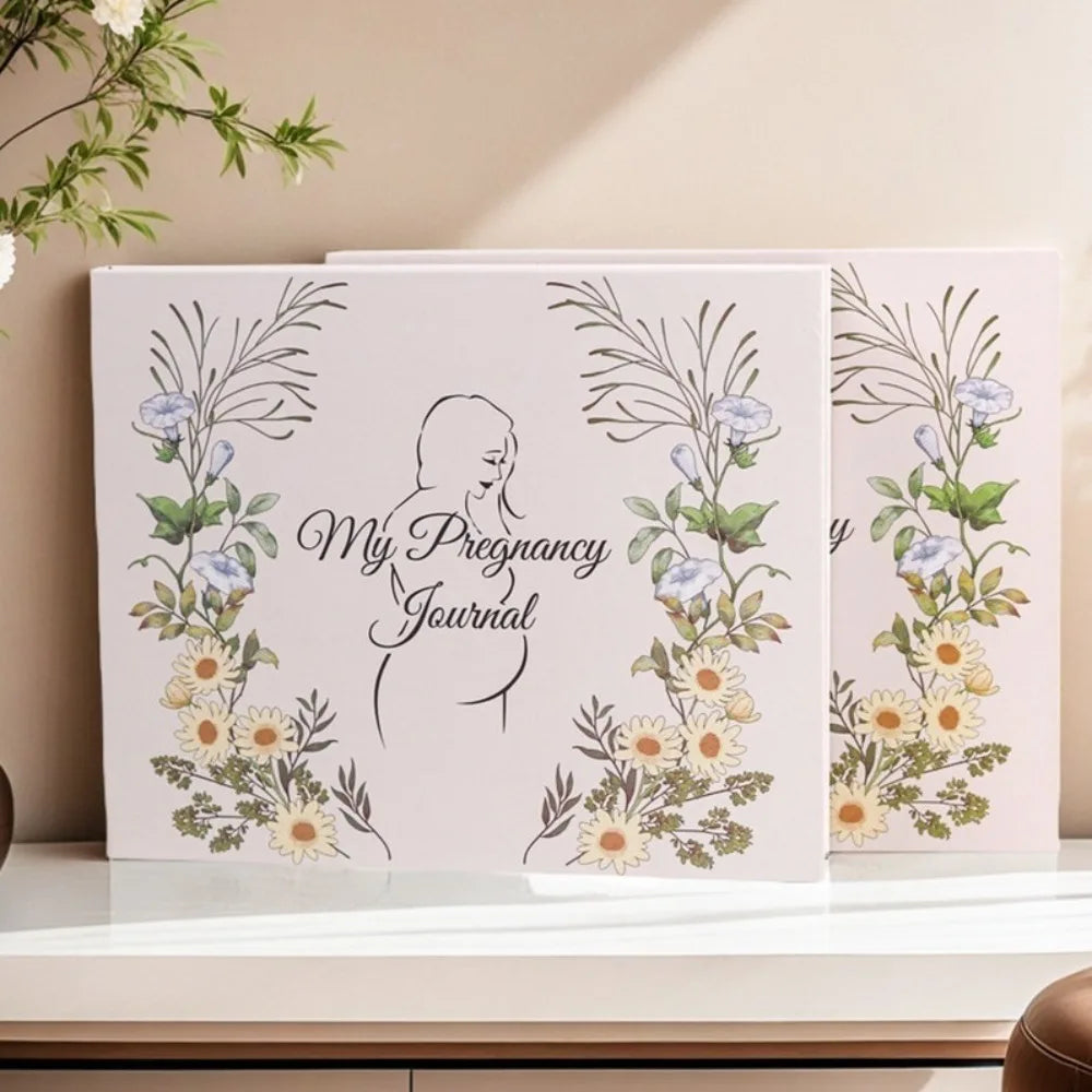 A set of three pregnancy journey journals featuring floral illustrations and a silhouette of a pregnant woman.