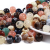 A collection of 50 imitation jade acrylic cloud beads in various translucent and opaque colors arranged on a white dish.