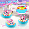 A pink unicorn foam furniture protector disk with LED lights and music resting on a white surface.