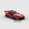 A red model of a sports car built from building blocks.